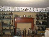 Multitudes of antique, primitive, vintage kitchen gadgets, utensils, etc
Heart Pine fireplace mantle.