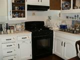 Basement apartment kitchen full of vintage blue and white dishes, cookware