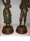 Close up of Faux painted wood base of bronzed statues