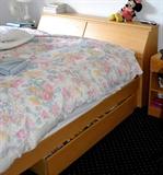 Bed has a pull out draw full storage headboard.  Also comes with two end tables.