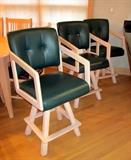 Swivel counter height arm chairs, hunter green vinyl seats and backs