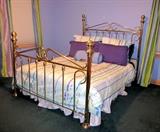 Queen size metal frame bed complete with mattress and box spring.
