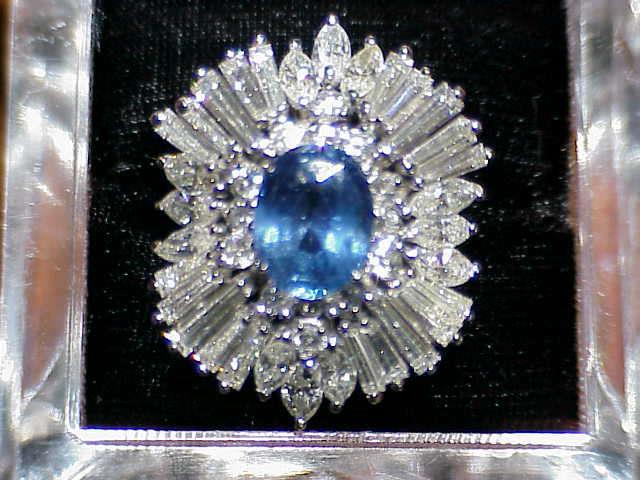 Sapphire & Diamond Ring Platinum mounting holding a 4.12 carat oval Sapphire surrounded bu 20 baquettes, 12 marquis & 14 round diamonds