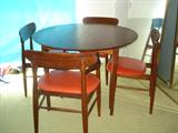 Table w/2 leaves and table protectors and 4 chairs. by Walter Weber