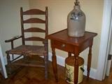 19th C. Ladderback arm chair, Cherry one drawer stand and a salt glazed jug signed Pottery Works little West 12th St. N.Y.