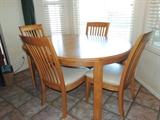 Oak Bassett Table with one leaf and four Chairs.