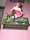 girl catching butterflies cast iron bank