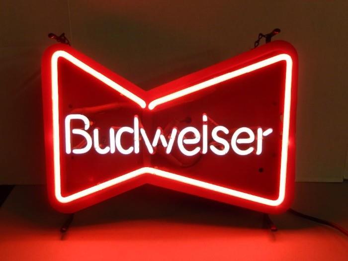 	Budweiser neon sign; Classic bow tie shaped logo neon sign. In working condition. Stamped on the back August 1989. It does not sit level and is made designed to hang from the chain. Measures 14 3/4H x 18 3/4W. 