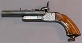 Lot#33, EUROPEAN DOUBLE BARREL, HIDDEN TRIGGER PISTOL, C1840-50, L 4 1/2" BBL,Approximately .32 Cal., 4 1/2'' barrel length. Carved grips and engraved cross pattern on frame. Lanyard ring on grip. Completely unmarked. C-1840-1850.