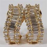 Lot#65, 18 KT YELLOW GOLD, DIAMOND CLIP EARRINGS,18kt yellow gold diamond clip earrings, with baguette and round cut diamonds, weighing 3.00 carats total, having a G-color, VS-2 clarity rating. The total weight of the earrings is 9.4 grams.