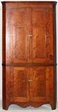 Lot#95, CHERRY CORNER CABINET, H 89", W 46", D 24"having crown molding, two upper paneled cabinet doors opening to three shelves. Lower paneled cabinet doors opening to single shelf. Both having brass latches; Contoured front skirt and legs.