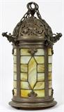 Lot#105, LEADED GLASS LANTERN STYLE CHANDELIER, H 17", DIA 8"hanging lamp/chandelier, pierced design rounded top with acorn finial, cylindrical body, caramel glass throughout and on underside. Suspended by chains. Gargoyles on edge of top.