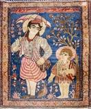 Lot#112, ANTIQUE PERSIAN, KASHAN RUG, HAND WOVEN WOOL, C. 1850-70 W 2' 1", L 2' 7",a picture on blue ground of two male figures: a man and young boy with trees in background and bird at their feet; Written in Farsi across the top: "The Prophet of Jesus and Mary".