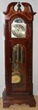 Lot#142, SLIGH GRANDFATHER CLOCK MAHOGANY H 80" W 24"D 14.5". Three brass weights. Battery operated. Revolving moon phase dial. Mahogany with satinwood. C - D for chimes.