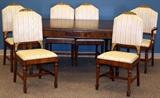 Lot#178, UNION FURNITURE, WALNUT DINING ROOM SET, 13 PCS.includes one dining table, 30" H. x 60" L. x 44" W. having two tapered and fluted legs at each corner and three leaves, each 12" W.; one buffet having burl veneer back splash and carved floral crest, three center drawers with top being a shallow flatware drawer having a partitioned velvet interior; all three flanked by a two cabinet doors with column and floral vase motif in relief on each door, opening to single shelf cabinets; all supported by acanthus leaf form feet.40" H. x 72" W. x 21" D.; one server with backsplash having burl trim and fruit inlays with carved leaf motif, full width top drawer above two cabinet doors opening to single shelf cabinet; pillar and floral vase overlays in relief on doors, 38" H. x 44" W. x 20" D., acanthus leaf form feet. One china cabinet, having a carved crest with two glass framed cabinet doors opening to two shelves flanked by 1/2 hexagon front corner frames. Lower full width shallow drawer