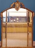 Lot#187, FRENCH, GILT WOOD WALL MIRROR, C1900, H 41", W 29"having an arched floral painted crest with acanthus leaf highlights, three vertical partitioned mirror panels with one being a wider center panel. Gilt wood and gesso frame.