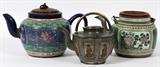 Lot#190, CHINESE POTTERY AND PEWTER, TEAPOTS, 19TH C, 3 PCS., H 6" - 7"two of hand painted pottery one having a pierced design spout, non-matching lid; pot and lid signed; second pottery pot hand painted , hammered non - matching brass lid, signed on underside; (spout repaired); third pewter and copper inlay teapot with fable characters, ring handle;