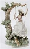 Lot#212, LLADRO PORCELAIN FIGURINE, H 15", W 11", GIRL ON A SWING,large Lladro figurine, 15" H. depicting a Victorian girl on a swing, suspended from a tree branch;