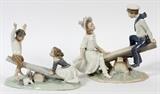 Lot#215, LLADRO PORCELAIN FIGURINES, 2 PCS., H 7" & 9", L 9", BOYS AND GIRLS ON TEETER TOTTERS,one depicts a young boy and girl on a teeter totter, 7" H. x 9" L.; second depicts an older boy dressed in a sailor suit and a girl wearing a large bonnet also on a teeter totter.