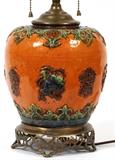 Lot#276, CHINESE POTTERY LAMP, H 21" DIA 7"Having an orange ground with green and blue designs. Pierced design brass footed base.
