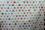 Lot#310, HAND MADE QUILT CIRCA 1920 TO 1940 W 76" L 90"Handmade quilt in a 6 pointed star pattern circa 1920 to 1940. This pattern depicts a 6 pointed star inside a hexagon block which is surrounded by another 6 pointed star. Quilt is hand pieced and quilted. The edge does not have trim. The front and back of the quilt has been sewn by hand along the edge. The head and foot of the quilt each have a triangle edge. The right and left sides of the quilt have been finished in a half hexagon edge. The quilting is very simple and follows along the edges of the quilt pieces. One small 1/2" stain. Otherwise the quilt is in very good condition.