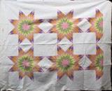 Lot#313, LONE STAR QUILT CIRCA 1890 TO 1925 W 68" L 82"Handmade quilt lone star pattern circa 1890 to 1925. This quilt has been pieced together and quilted by hand. The only machine stitching is along the area where the outer white border has been attached and along the finished edge. The quilting on the white panels and outer border is a fine example of white work and similar to trapunto quilting although it is not as plush as trapunto. The pieces that make up the star are calico.
