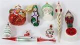 Lot#401, RADKO ASSORTED GLASS ORNAMENTS, EIGHT, H 3" - 8", W 3" - 8"One Christmas Tree, One Santa in Gift Bag, One Bottle with Heart, One Santa on Torpedo, One Santa head on Twisted Stem, One House, One Fishman, and One Solider.