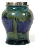 Lot#1004, MOORCROFT 'MOONLIT BLUE' POTTERY CABINET VASE WITH SILVERPLATE RIM, C. 1925, H 3 1/2"Inverted baluster-form with landscape motif in shades of blue, having a silverplate rim made by William Hutton & Sons; impressed "Moorcroft, Made in England" (see additional photo).