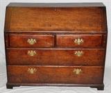 Lot#1013, ENGLISH OAK SLANT-FRONT DESK, 18TH C., H 40", W 47", D 20 1/2"Slant front hinges open to six small drawers, two long slots, and a single door. Having two half-width drawers above two full-width drawers. Raised on bracket feet.