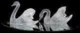 Lot#1058, LALIQUE FROSTED GLASS 'MIROIR CYGNES', PAIR, L 12" & 14". Including 1 "Tete Droit", H.9 1/2", L.12", and 1 "Tete Penchee", H.6 1/2", L.14"; each is signed "Lalique France", set on a mirrored plateau etched to resemble rippling water, L.32".