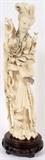 Lot#1144, CHINESE IVORY FIGURE OF GUANYIN, H 12"Depicting a woman holding a bouquet of flowers. Standing on a wood base H 1.25".
