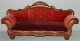 Lot#1225, AMERICAN EMPIRE CARVED MAHOGANY SOFA, C. 1840, L 80"American Empire. Having a carved mahogany frame, with a crest of rose and leaf design. Upholstered in a peach velour fabric with brass tack trim along the bottom. Measures H.40" x 80" x 24".