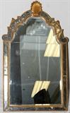 Lot#1239, CONTINENTAL NEOCLASSICAL SILVERED MIRROR, 52" X 31"The arched crest surmounted with a shell over the beveled plates set within a mirrored frame.