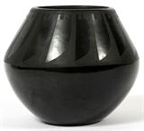 Lot#1289, SAN ILDEFONSO BLACKWARE POTTERY JAR BY ROSALIE, W 5 1/2"Decorated in black on black. Signed Rosalie. San Ildefonso pueblo. H 4 3/4" W 5 1/2". By Rosalie Aguilar.