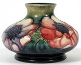 Lot#1291, MOORCROFT POTTERY ANEMONE VASE, C. 1945-49, H 3"Bold floral motif on a shaded green and blue ground, marked at the underside.