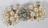 Lot#2079, DOUBLE STRAND PEARL BRACELET, 2.6CT YELLOW DIAMOND CLASP W 3/4", L 7"Clasp is 1 1/4" x 3/4". Includes 16 8.5mm pearls on each with four spacers and small round diamonds on top. Approx. 2.6ct marquise cut fancy yellow diamond measuring 17 X 6.5 X 4.3mm. Surrounded by 10 baguettes and 10 marquise cut diamonds at approx. 10pts each for 2cttw. TW. 43.3 GR.