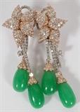 Lot#2084, 18 KT WHITE & ROSE GOLD, JADE AND DIAMOND DANGLE EARRINGS,18kt white and rose gold dangle earrings, with diamond flower studs and three dangles of apple green jade gems and diamonds. Jade gems weigh 17.00 carats total. Diamonds are round and full cut, weighing 6.00 carats total. The total weight of the earrings is 34.2gms.