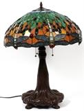Lot#2182, TIFFANY STYLE LEADED GLASS, THREE-LIGHT TABLE LAMP, H 26", DIA 20"The modern lamp, in the Dragonfly pattern, features multi-colored cabochons and is atop a footed base.