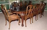 Lot#2194, IRISH MAHOGANY OVAL DINING TABLE & SET OF (10) CHAIRS, WITH TWO LEAVES,The table (H 32", W ca. 45", L 60" closed, L ca. 103" extended with leaves) has two wide leaves, each 23" wide, on heavily carved cabriole legs with paw feet. Together with a set of dining chairs having heavily carved splats above horseshoe seats with inset leather and including 2 uniquely carved armchairs and 8 side chairs. Chippendale style.