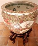 Lot#2284, CHINESE PORCELAIN HAND PAINTED JARDINIÈRE H 17'' DIA 19''bared hand covered wood, dia. 16''. Children, barrels, and flower motif