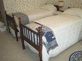 Antique twin youth beds (slightly smaller than a twin) with twin bedding