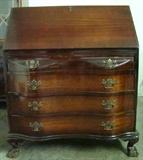 Cherry Fold Down Desk with Ox Bow Front and Claw and Ball Feet. Interior of desk contains original storage with single middle door and four small pull out drawers. Desk sits on four pull out drawers which all feature the "Ox Bow" contours. Measures 36"w. x 42"h. x 18"d.