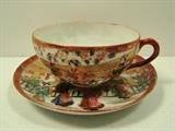 Unmarked Porcelain Cup and Saucer. Cup measures 2"h. and saucer 5.5"w. and has a tiny chip on its rim. 