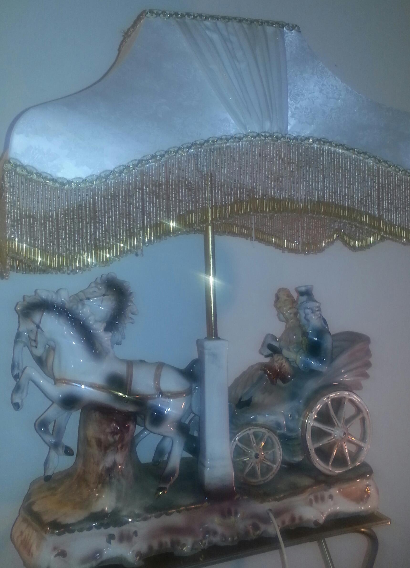 Exquisite ornate detailed lamp couple chauffeured by horses