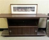 Television stand/Media Center with framed art sitting on top.