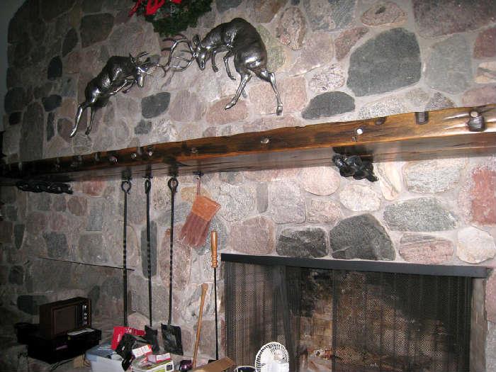 Magnificent mantle made from wood of recovered shipwreck ...hanging above are solid copper fighting bucks.  Covered in silver colored metal