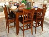 9-piece Counter Height Wood Dining Table with 8 matching chairs.  Includes custom cut glass protector for table top.