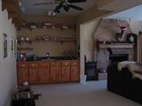 Lower Level with a LARGE area Finished, Including this Wet Bar Area.  Barware and Glassware, Taxidermy Buck, Large Sectional