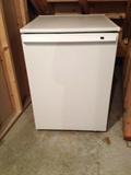 Small GE Refrigerator (View is in unfinished basement under stairway.