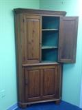 corner cupboard painted green inside